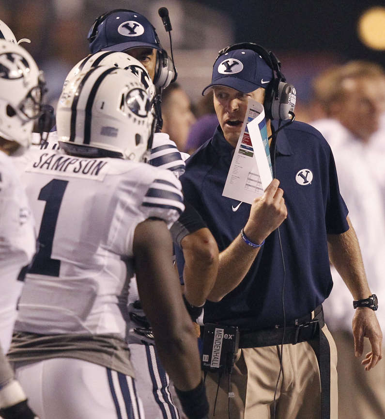 Head coach Bronco Mendenhall of the Brigham Young Cougars talks with players during NCAA football in Boise (Ravell Call, Deseret News)