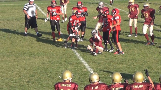 A Nephi player sits on the ground, apparently injured, after a hard hit from a Monroe player.
