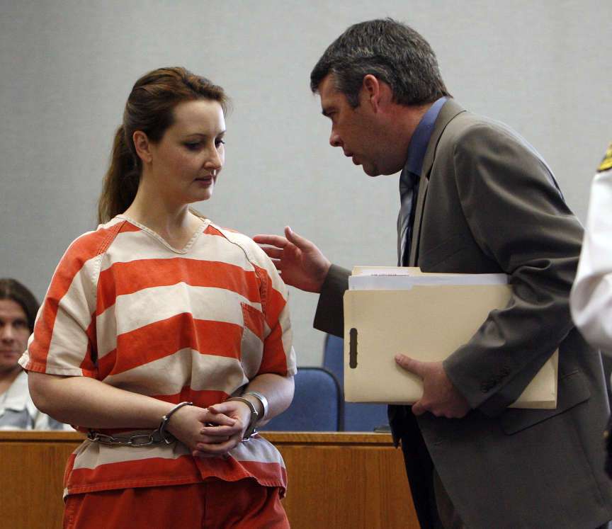 Gypsy Willis, the girlfriend of Martin MacNeill, talks with her attorney, John Easton, as she has her initial appearance in Provo's 4th District Court on identity fraud, false and inconsistent material and unlawful lien. Provo, Utah Tuesday, Feb. 15, 2011.
