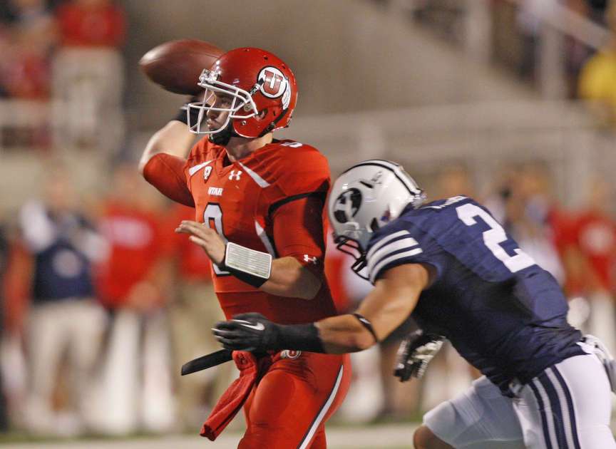 Utah Utes quarterback Jon Hays (9) passes before Brigham Young Cougars linebacker Spencer Hadley (2) hits him (Tom Smart, Deseret News)