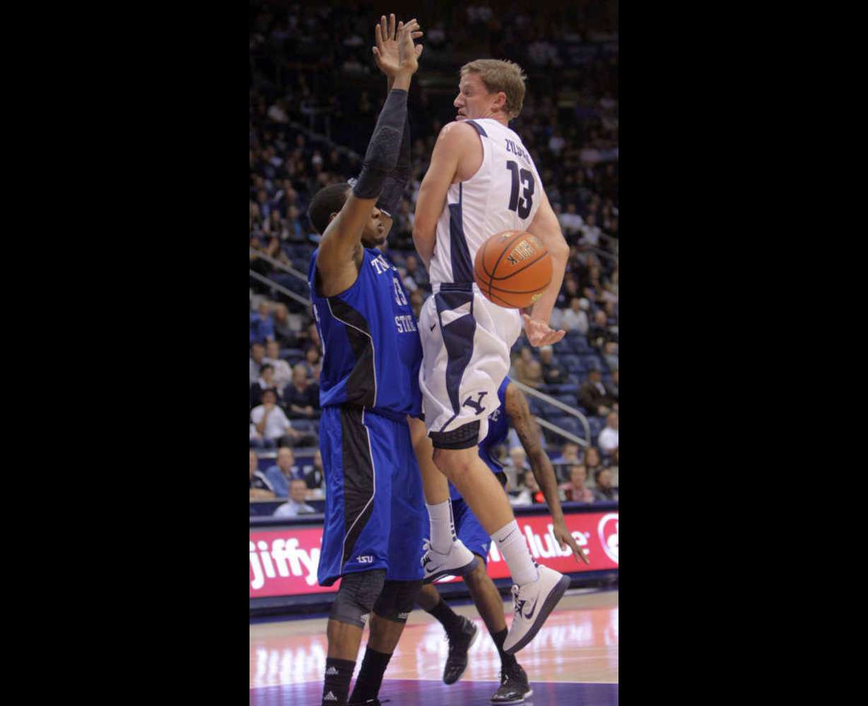 Brigham Young Cougars guard Brock Zylstra (13) passes behind his back on Tennessee State Tigers forward Robert Covington (33) (Jeffrey D. Allred, Deseret News)
