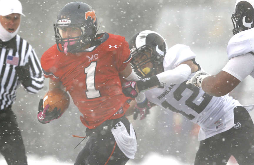 Mountain Crest's #1 Eddy Hall gains yardage against Highland High's #12 Jerry Padilla during the 4A football semifinal at Rice Eccles Stadium (Laura Seitz, Deseret News)