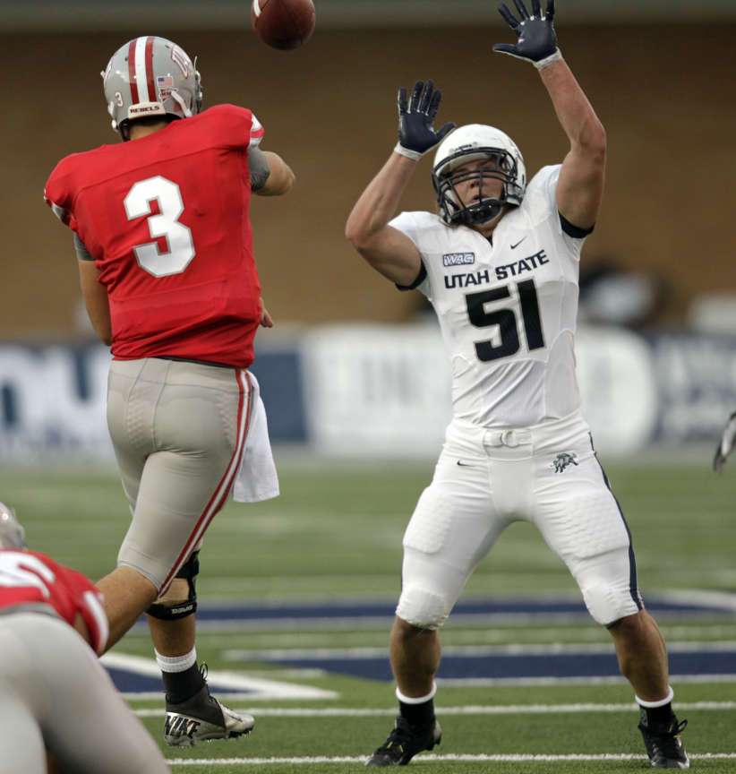 Utah State Aggies linebacker Jake Doughty (51) tries to block the pass by UNLV Rebels quarterback Nick Sherry (3) (Jeffrey D. Allred, Deseret News)