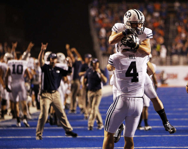 Taysom Hill, back to camera, of the Brigham Young Cougars celebrates scoring BYU's only touchdown during NCAA football in Boise (Ravell Call, Deseret News)