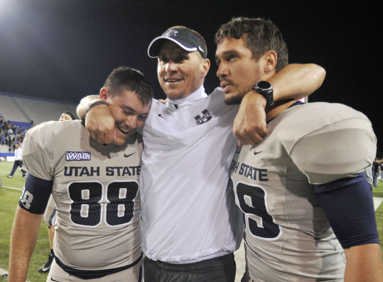 Utah State head coach Gary Andersen , punter Tyler Bennett (88) and teammate celebrate after winning 48-41 against 19th ranked La Tech (AP Photo/Kita Wright)