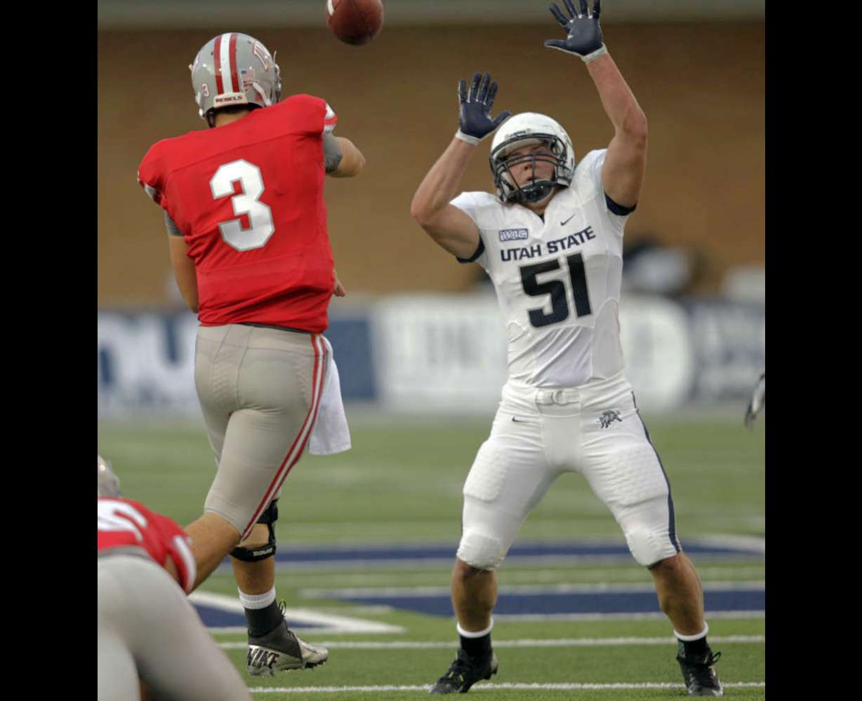 Utah State Aggies linebacker Jake Doughty (51) tries to block the pass by UNLV Rebels quarterback Nick Sherry (3) (Jeffrey D. Allred, Deseret News)