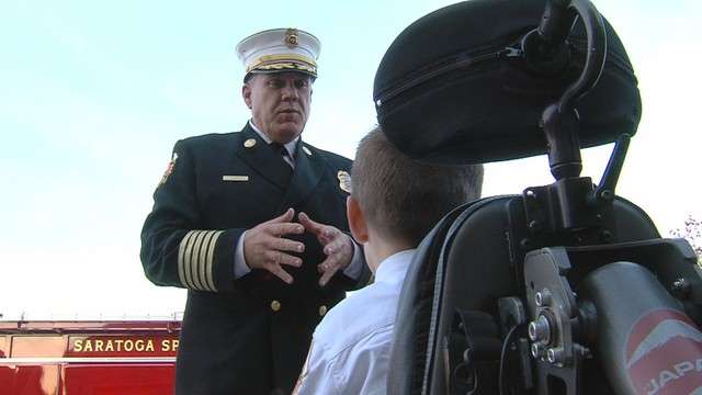 Fire Chief Jess Campbell explains the day's activities and responsibilities as chief to Jonah Bradshaw.