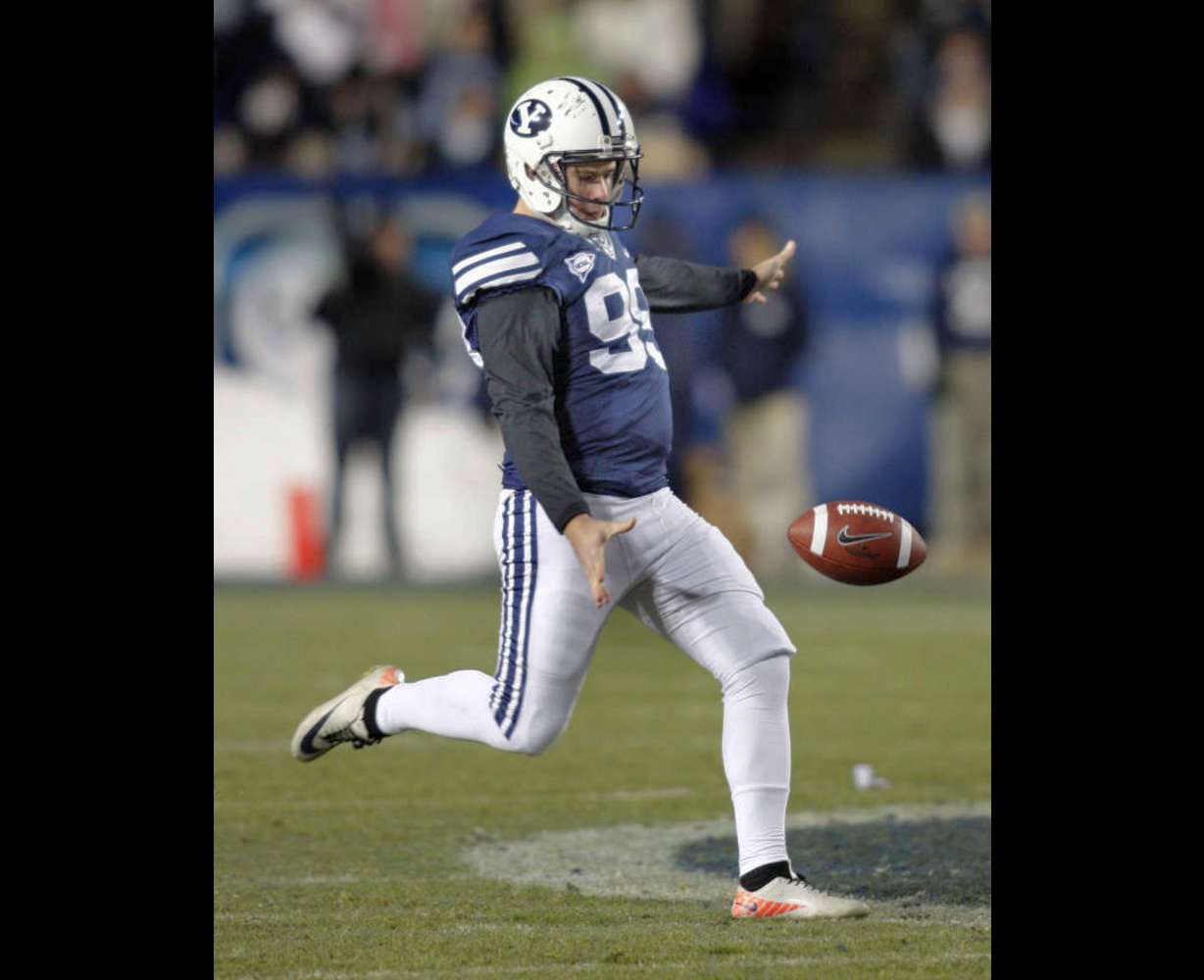 Brigham Young Cougars punter Riley Stephenson (99) punts during first half action as BYU plays Idaho in the Cougar's final home football game (Tom Smart, Deseret News)