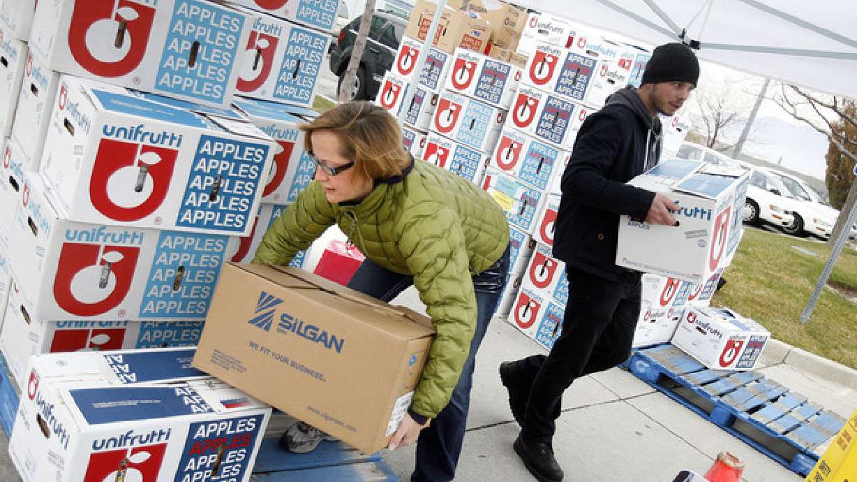 Amy Rich and David Clark volunteer their time giving out boxes of bread at the Utah Food Bank in Salt Lake City on Wednesday, Dec. 5, 2012. Food insecurity rates jumped up to nearly 10% in Utah at points during the pandemic due, in part, to food assistance becoming difficult for some to access.
