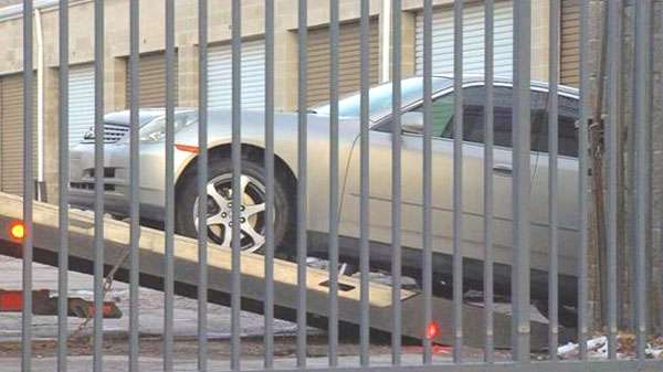 Car being towed near storage unit