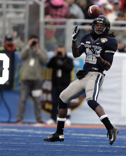 Utah State's Chuck Jacobs (10) makes a 35-yard reception at the end of the first half against Toledo to set up a field goal during an NCAA college football game on Saturday, Dec. 15, 2012, in Boise, Idaho. (AP Photo/Matt Cilley)