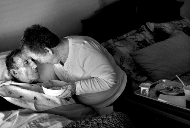 Jolean Sloan feeds her husband breakfast on Feb. 16, 2012. Sloan took care of her husband as long as she could but then turned to hospice care when Richard became bedridden.