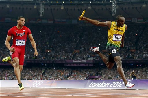 Usain Bolt, right, of Jamaica, crosses the finish line ahead of Ryan Bailey, of the United States, to win the men's 4x100-meter relay final and set a new world record.