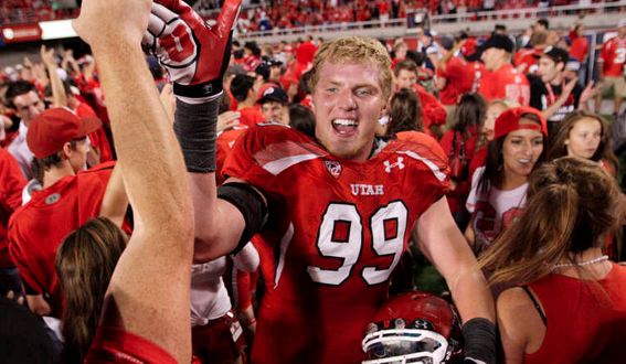 Utah fans storm the field and high five Utah Utes defensive end Joe Kruger (99) after the Utes beat BYU in Salt Lake City Sunday, Sept. 16, 2012. in Salt Lake City Sunday, Sept. 16, 2012. (Submission date: 09/16/2012)