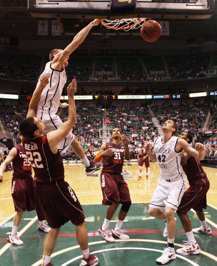 BYU's Josh Sharp dunks over Christian Beyer as BYU and Virginia Tech play Saturday, Dec. 29, 2012 at Energy Solutions arena. BYU won 97-71. (Scott G Winterton, Deseret News)