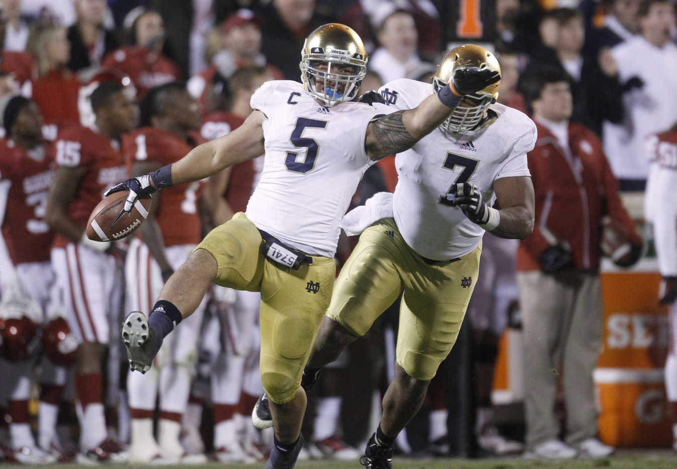 Notre Dame linebacker Manti Te'o (5)celebrates with teammate Stephon Tuitt (7) after an interception against Oklahoma (AP Photo/Sue Ogrocki)