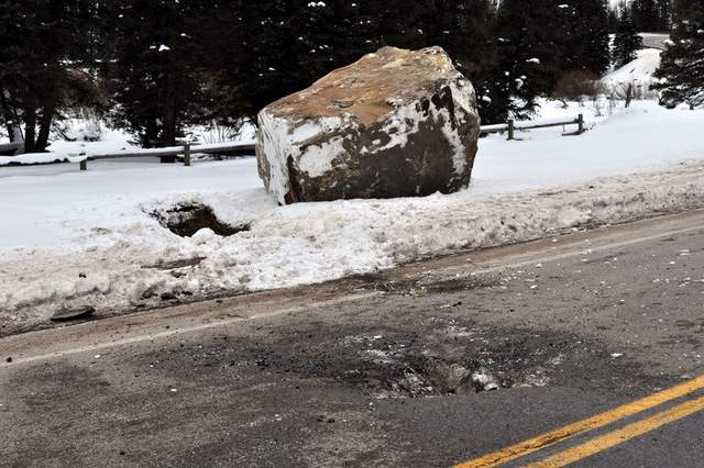 Boulders leave craters in road after rockslide