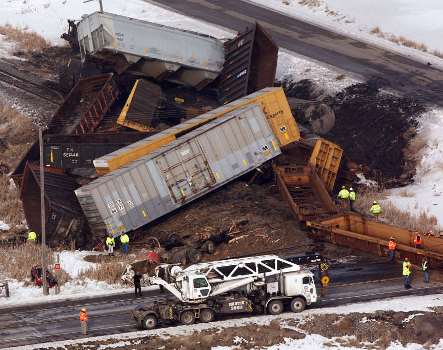 Train, dump truck crash kills one, derails train