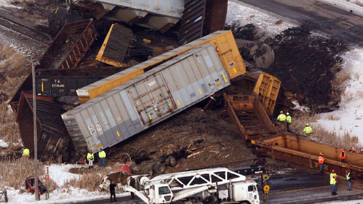 Train, dump truck crash kills one, derails train