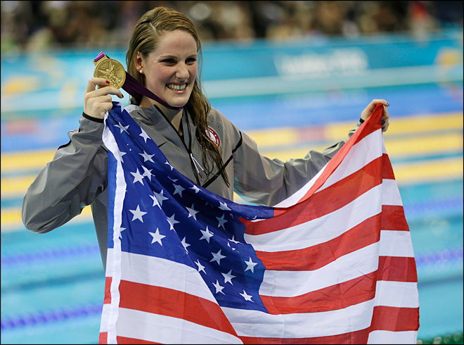 United States' Missy Franklin poses for photographers with her gold medal for the women's 100-meter backstroke swimming final at the Aquatics Centre in the Olympic Park during the 2012 Summer Olympics in London, Monday, July 30, 2012. (AP Photo/David J. Phillip)