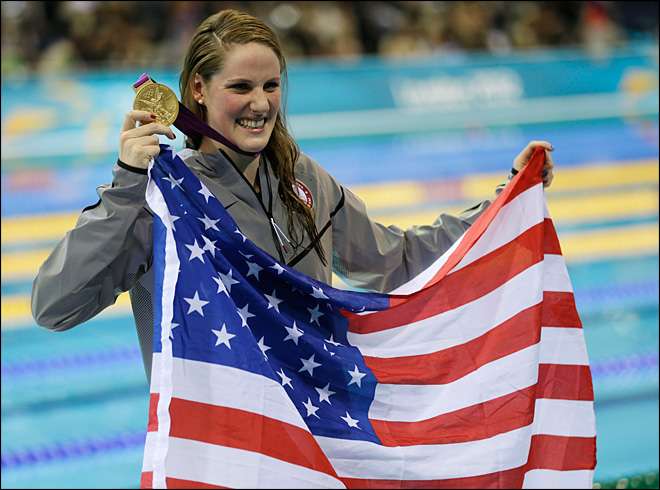 United States' Missy Franklin poses for photographers with her gold medal for the women's 100-meter backstroke swimming final at the Aquatics Centre in the Olympic Park during the 2012 Summer Olympics in London, Monday, July 30, 2012. (AP Photo/David J. Phillip)