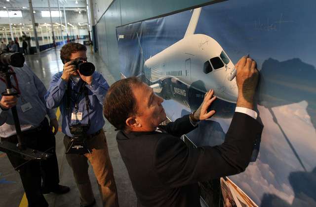 Gov. Gary R. Herbert signs a banner as Boeing celebrates the opening of a new manufacturing facility in West Jordan.