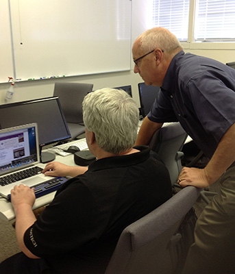 J. R. Westmoreland and associate professor Rob Hilton work on app development.