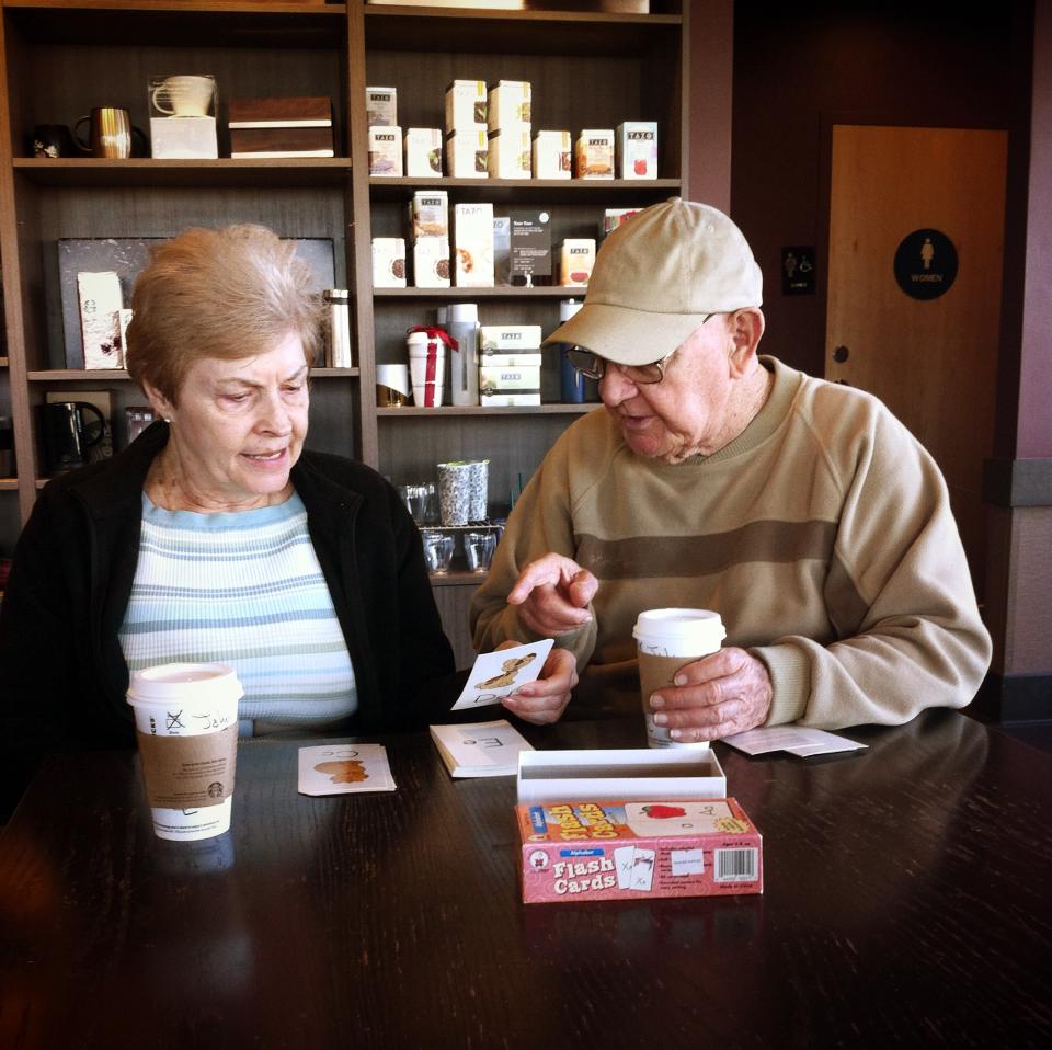 Photo of elderly man teaching girlfriend to read goes viral