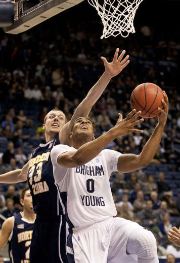 BYU forward Brandon Davies (0) goes up for a layup past Northern Arizona forward Max Jacobsen (33) (Ben Brewer, Deseret News)