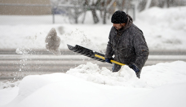 Ignacio Primatel shovels heavy ice off the sidewalk on 3300 South in Salt Lake County Tuesday, Jan. 29, 2013. (Photo: Jeffrey D. Allred, Deseret News)