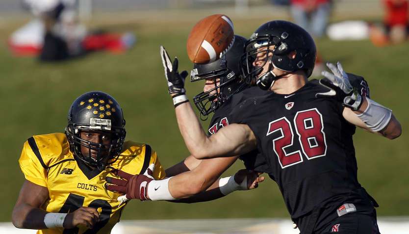 Austin Tate of Northridge pulls in a pass while defended by Dorien Banks of Cottonwood at left during high school football played in Layton, Friday, Oct. 28, 2011. Banks signed with SUU.