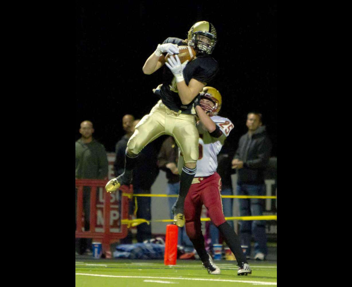 Desert Hills' Ty Rutledge makes a catch from Nate Brinker and runs it in for a touchdown during the Thunder's 23-21 win over Cedar in the 3A semifinals at Hansen Stadium in St. George on Friday, Nov. 11, 2011. Rutledge signed with SUU.