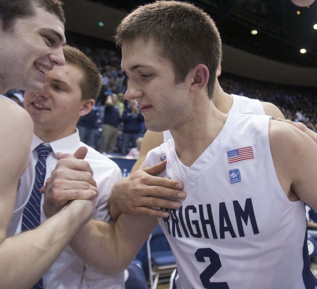 BYU's Craig Cusick and teammate Matt Carlino celebrates Cusick's game winning shot Tuesday, Feb. 19, 2013 in the Marriott Center giving BYU a 70-68 win over Utah State.