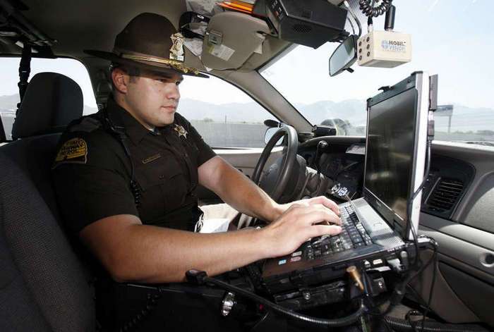 Trooper Mark Bricker of the Utah Highway Patrol records information during a traffic stop. (Ravell Call/Deseret News)
