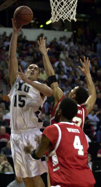 Mekeli Wesley of BYU attempts a shot against Wayland White and Patrick Dennehy of New Mexico. MWC tournament in Las Vegas, March 10, 2001. (Ravell Call/Deserert News)