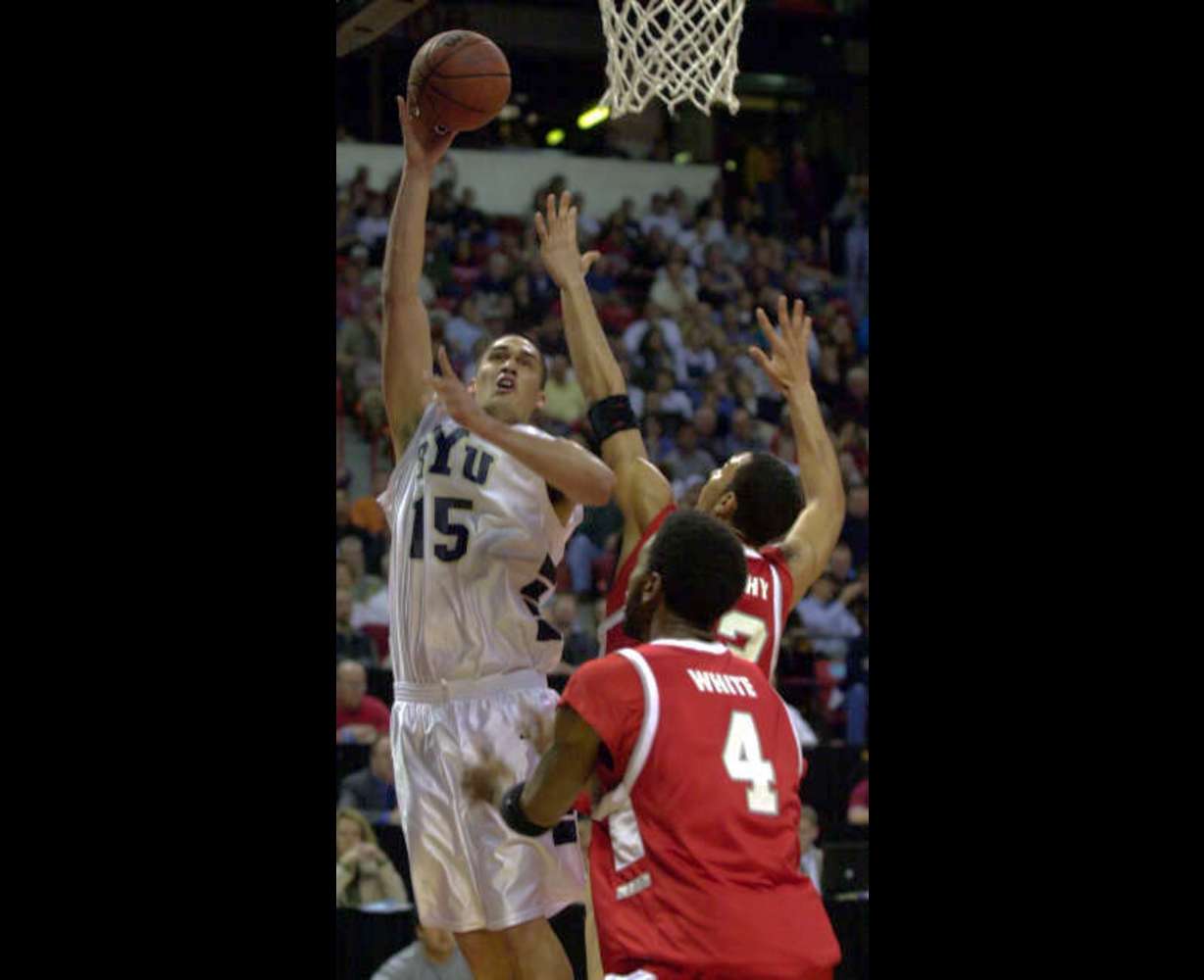 Mekeli Wesley of BYU attempts a shot against Wayland White and Patrick Dennehy of New Mexico. MWC tournament in Las Vegas, March 10, 2001. (Ravell Call/Deserert News)
