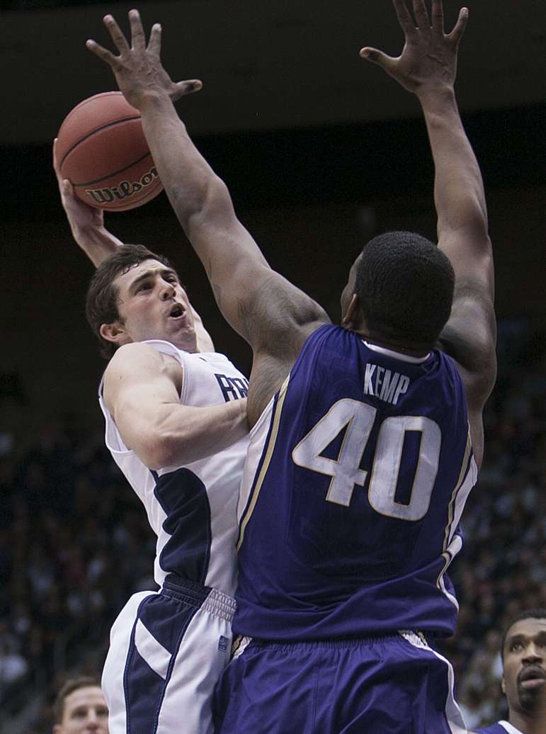 BYU's Matt Carlino drives on Shawn Kemp Jr. as BYU and Washington play in the first round of the NIT. BYU won 90-79. (Scott G. Winteron/Deseret News)