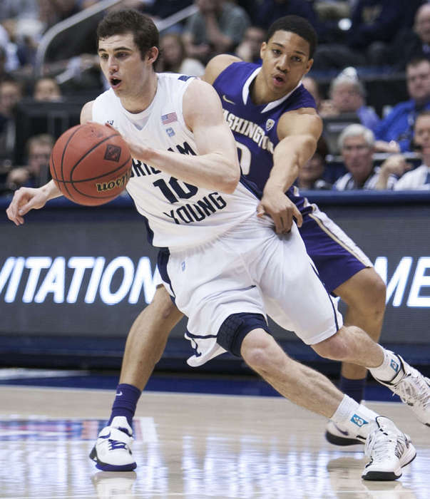 BYU's Matt Carlino dribbles away from Washington's Abdul Gaddy as BYU and Washington play in the first round of the NIT in the Marriott Center at BYU. (Scott G. Winterton/Deseret News)