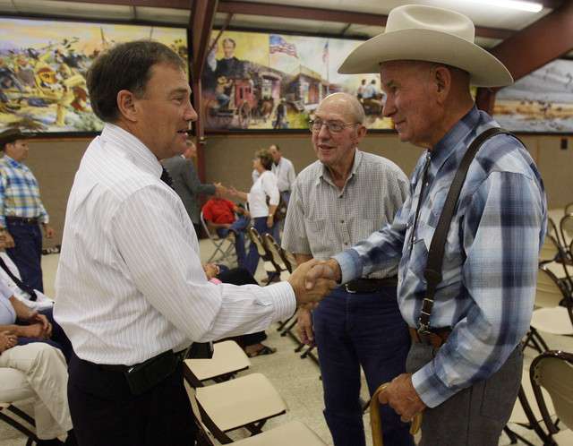 Governor Herbert shakes hands with Pete Shields (left) and Grant Nielson prior to a 2009 meeting of concerned citizens in Delta. (Photo: Scott G. Winterton, Deseret News)