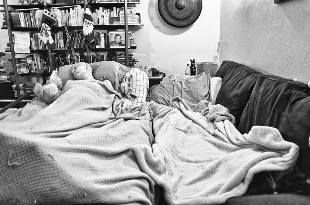 Jen resting in bed at home.