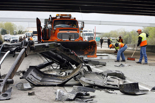 Officials investigate at the scene of an accident at 900 East on I-215 where a truck hit into the overpass, Monday, May 6, 2013.
(Ravell Call, Deseret News)