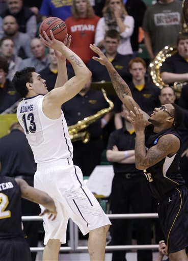 Pittsburgh's Steven Adams (13) shoots as Wichita State's Carl Hall (22) defends in the first half during a second round game in the NCAA college basketball tournament in Salt Lake City Thursday, March 21, 2013. (AP Photo/Rick Bowmer)