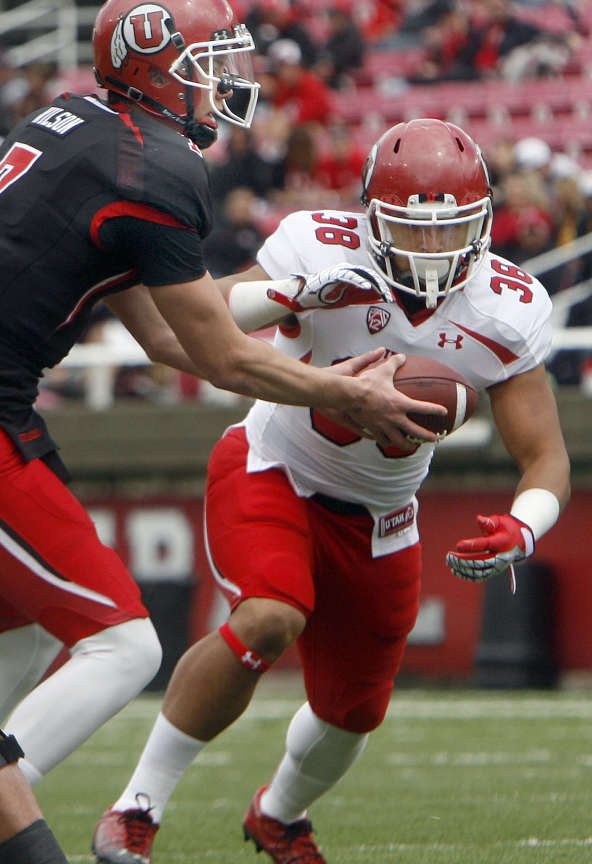QB Travis Wilson hands off to Karl Williams during the Red-White game at Rice-Eccles Stadium at the University of Utah in Salt Lake City on Saturday, April 20, 2013. (Laura Seitz/Deseret News)