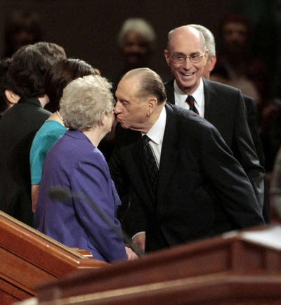 President Monson steals a kiss from his sweetheart on the stand after LDS general conference.
