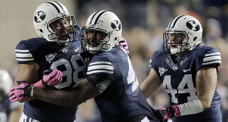 BYU DE Ziggy Ansah, congratulated by NT Romney Fuga (No. 98) and LB Brandon Ogletree (No. 44)