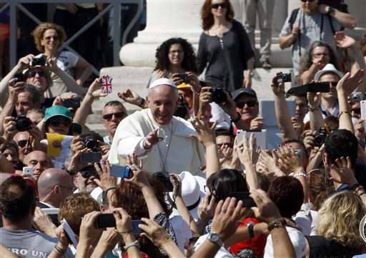 Pope Francis waves to faithful as he arrives for a Mass in St. Peter's
Square at the Vatican, Sunday, June 16, 2013.