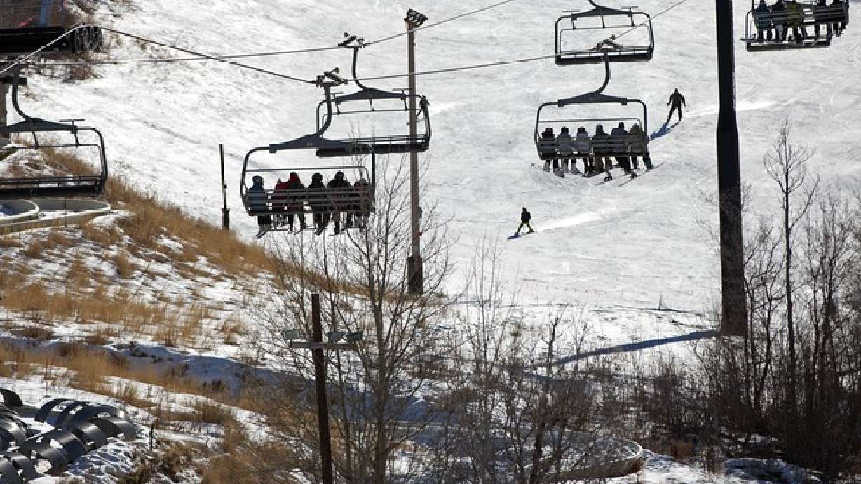 In this Jan. 14, 2012 photo, skiers make their way up the slopes near uncovered terrain at Park City Mountain Resort in Park City.