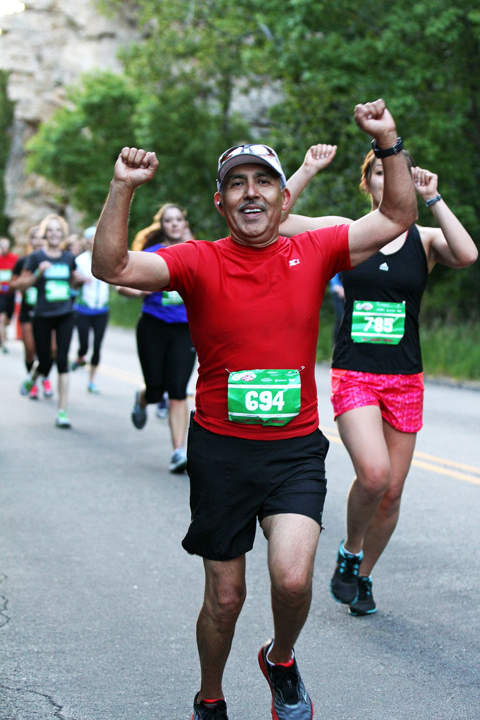 Carl Gallegos runs in the American Fork Canyon Half Marathon 
Saturday, June 15, 2013. Gallegos, 57, crossed the finished line in one 
hour, 56 minutes. He grabbed his medal and a bottle of water before 
telling a volunteer he needed to find the aid station. That's the last 
thing he remembers before going into cardiac arrest. (Photo: 
Zazoosh.com, Zazoosh Media Inc.)