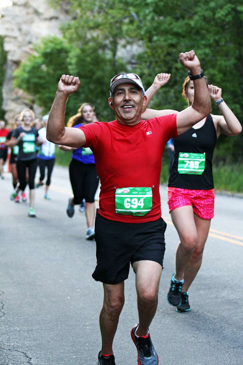 Carl Gallegos runs in the American Fork Canyon Half Marathon
Saturday, June 15, 2013. Gallegos, 57, crossed the finished line in one
hour, 56 minutes. He grabbed his medal and a bottle of water before
telling a volunteer he needed to find the aid station. That's the last
thing he remembers before going into cardiac arrest. (Photo:
Zazoosh.com, Zazoosh Media Inc.)