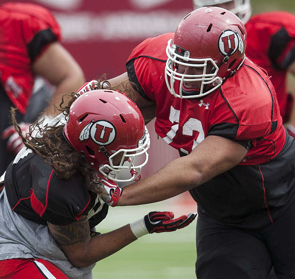 Utah's Jeremiah Poutasi pushes down on teammate 
Tevita Malafu during practice (Scott G 
Winterton, Deseret News)